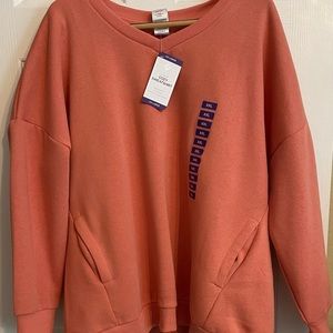 NWT Sweatshirt with pockets. Coral-Peach in color.